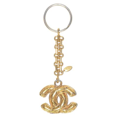 chanel perfume keychain|Chanel gold burst necklace.